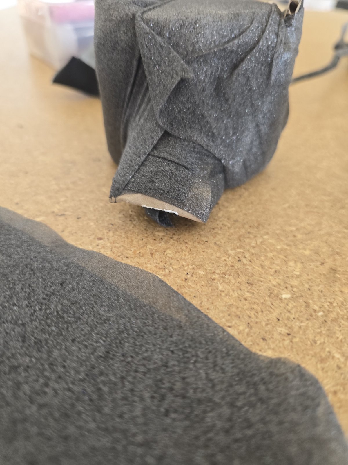 Cardboard head structure of the mouse puppet, wrapped for stability
