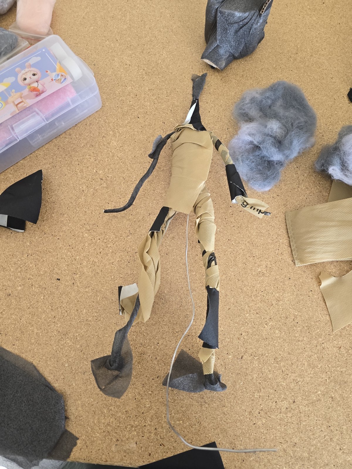 Wire puppet body wrapped in fabric tape