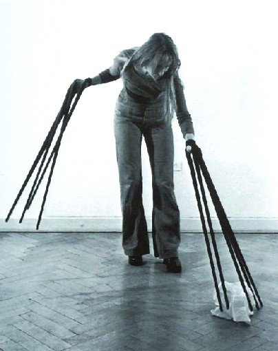 Rebecca Horn's Finger Gloves (1973): a figure wearing long finger extensions that reach the floor