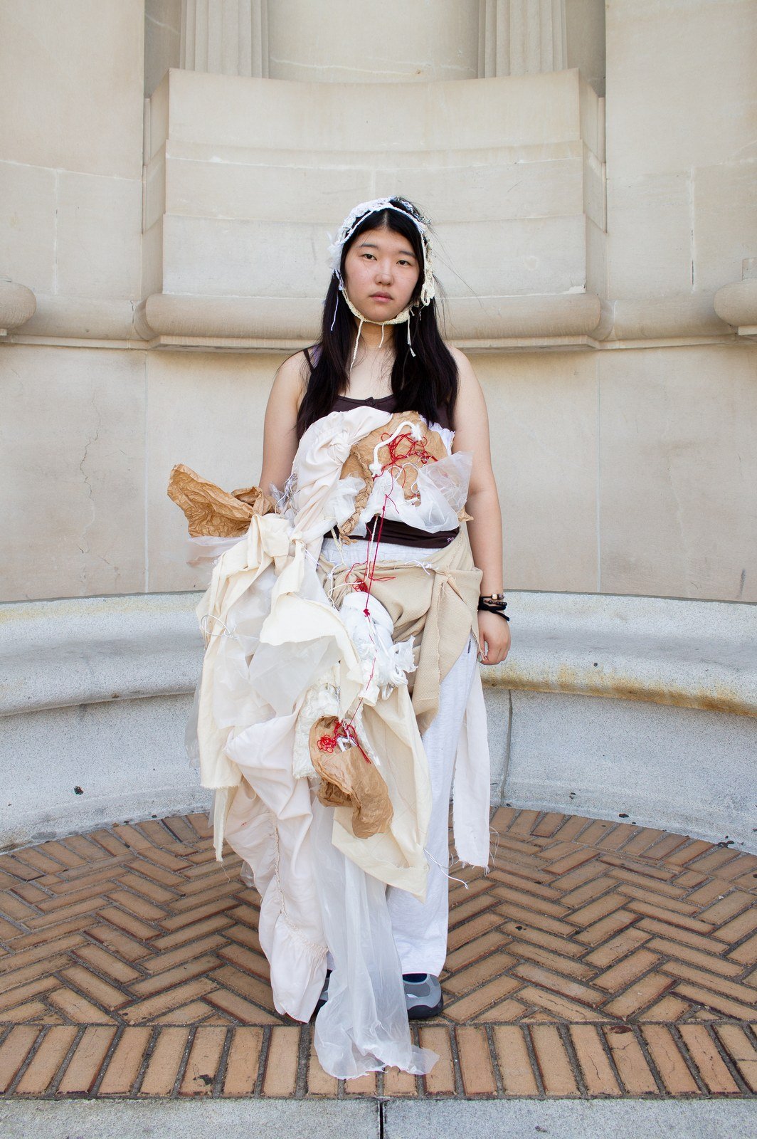 The finished sculpture dress, worn in front of a stone colonnade