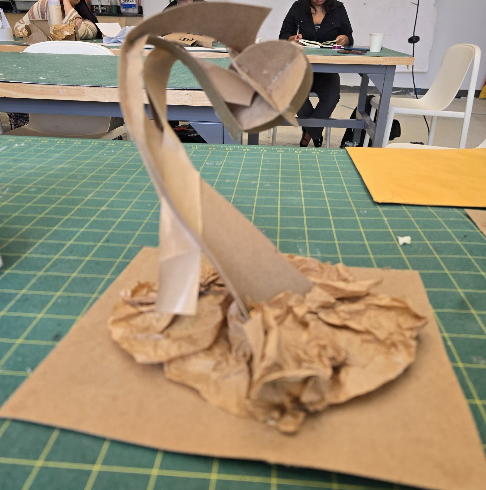 Cardboard maquette of the first study — curved paper meeting a spherical form