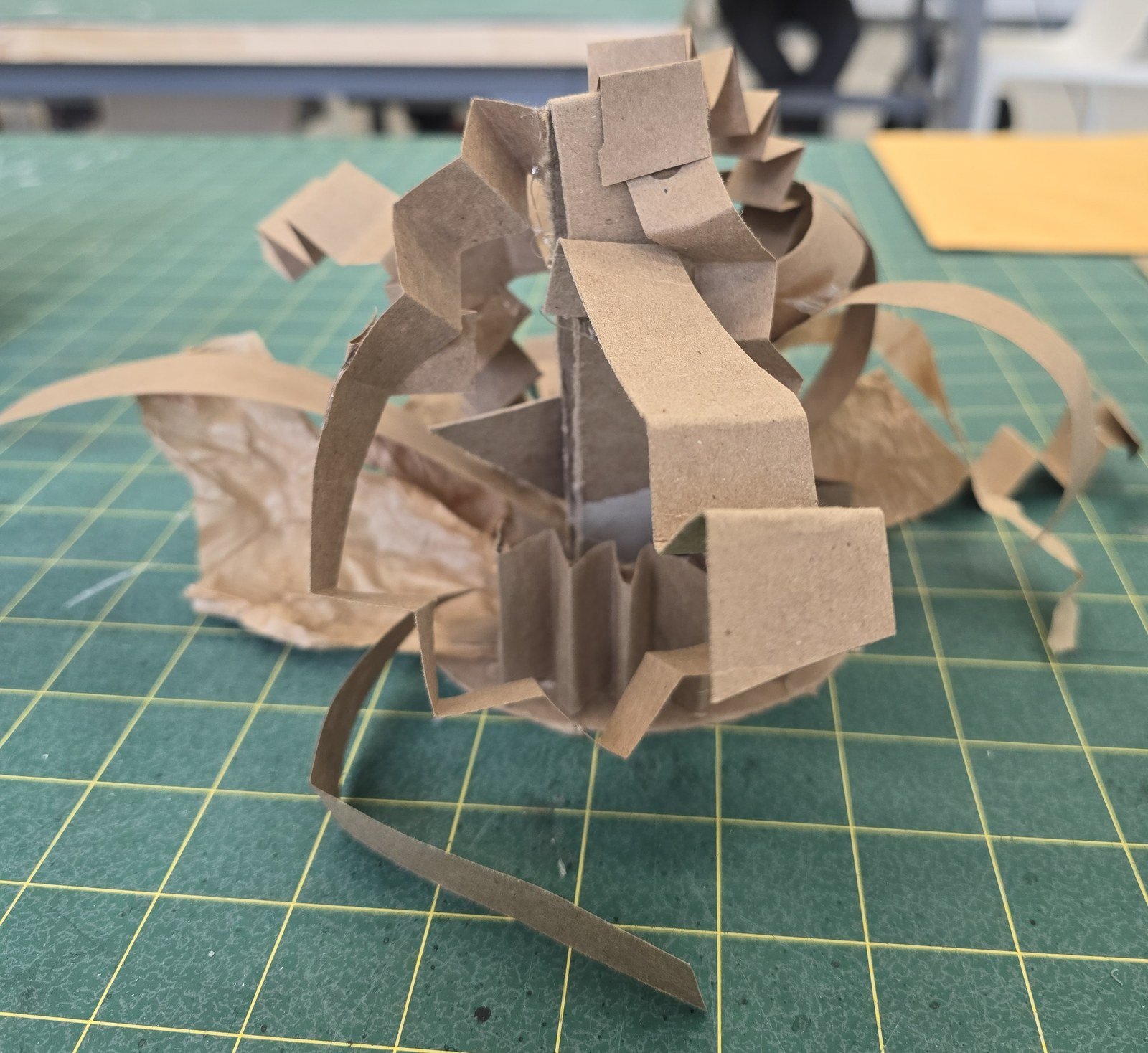 Cardboard maquette of the second study — narrow paper strips bursting outward