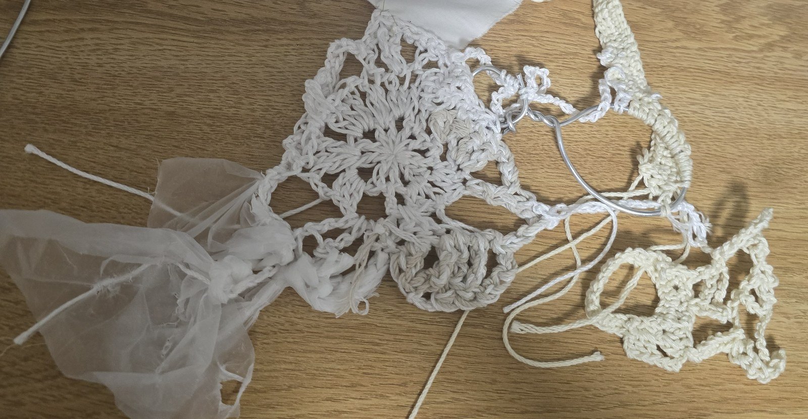Crocheted wire-and-yarn headdress laid flat